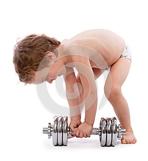 Little boy trying to lift heavy dumbbell photo