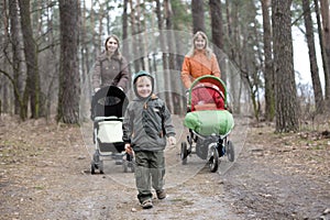 Little boy and two mums with carriages