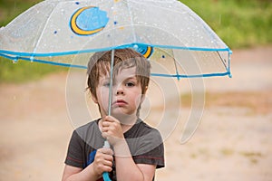 Little boy under umbrella