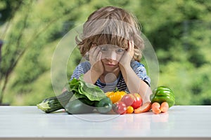 Little boy unhappy with vegetable meal