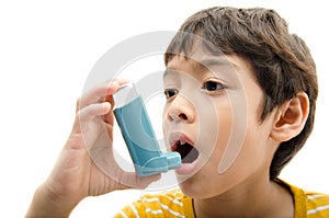 Little boy using Asthma inhaler for breathing photo