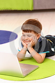 Little boy using computer at home