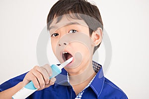 Little boy using electric toothbrushes dental healthcare on white background