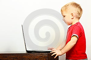 Little boy using laptop pc computer at home