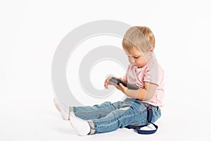 Little boy using mobile phone. Child playing on smartphone. Technology, mobile apps, children and parental advisory