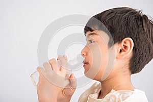 Little boy using salt water to clean his nose