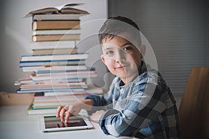 Little boy is using a tablet.