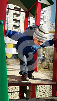 Little boy verifying height of slides
