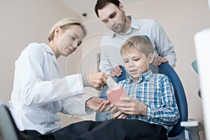 Little Boy Visiting Dentist with Dad
