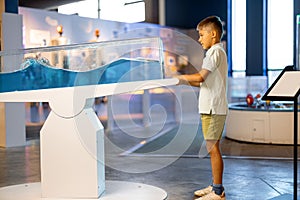 Little boy visits a science museum