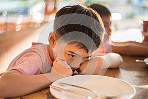 Little boy waiting for food in the restuarant