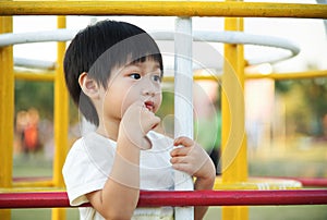 Little boy waiting and looking for his parent at playgroun