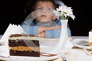 Little boy waiting patiently for cake photo