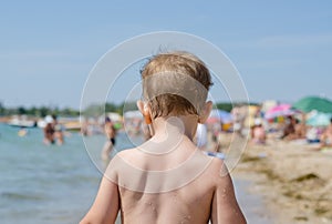 Little boy walking on the beach