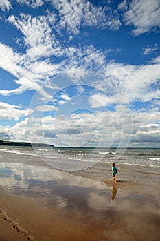 Little boy walking on the beach