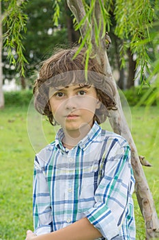 Little Boy walking in the park on a summer day