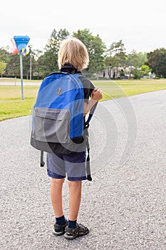 Little boy walking to school. Back to school concept. Child near school photo
