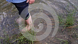 Little boy walks along the river. the child runs around the lake. slow motion. happy baby playing near the water. baby