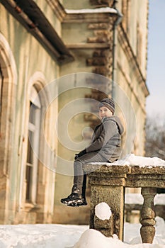 A little boy walks in the park in the winter weather, play snowballs and rejoiced. Waiting for Christmas mood