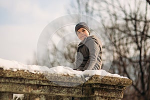 A little boy walks in the park in the winter weather, play snowballs and rejoiced. Waiting for Christmas mood