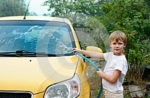 Little boy washing car