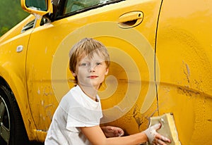 Little boy washing car