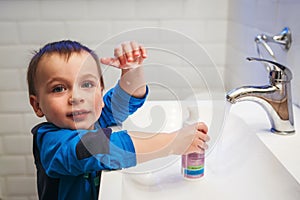 Little boy washing his hands