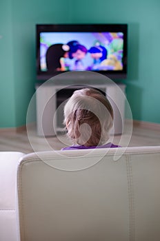 Little boy watching cartoon in television