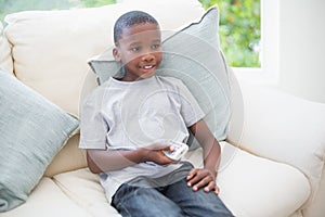 Little boy watching tv on the couch