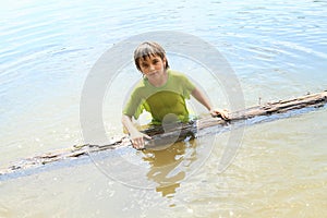 Little boy in water with trunk