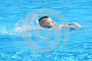 Little boy and watersports. Active holiday in the pool. swim practice