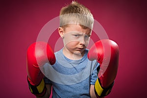 Little boy wearing boxing gloves