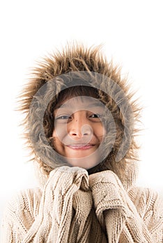 Little boy wearing fur coat protect from cold snow over head