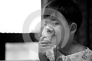 Little boy wearing oxygen mask in hospital ward