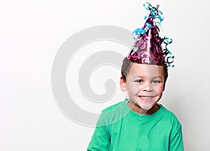 Little boy wearing a party hat and celebrating New Years