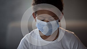 Little boy wearing protective medical mask, illness prevention, ebola epidemy