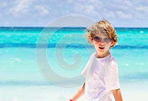 Little boy wearing sunglasses on tropical beach