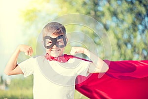 Little boy wearing superhero costume