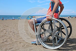 Little boy on the wheelchair on the beach at resort