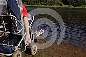 A little boy in a wheelchair by the river.