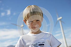 Little Boy With Wind Turbines In The Background