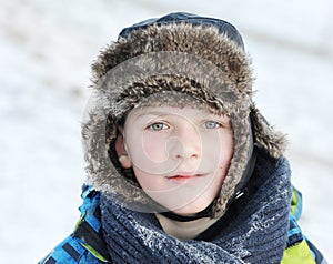 little boy in winter a fur hat in winter