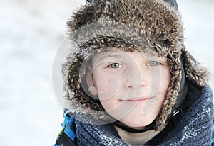 Little boy in winter a fur hat in winter