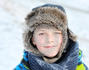 Little boy in winter a fur hat in winter