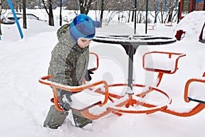 Little boy on winter playground