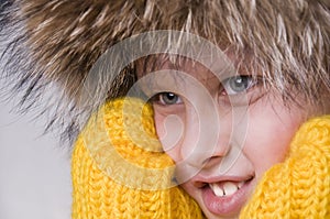 Little boy winter portrait in the fur-cap