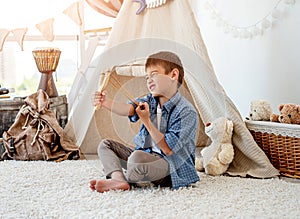 Little boy with wood slingshot