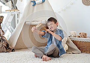 Little boy with wood slingshot