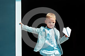 Little boy with wooden plane, boy wants to become pilot and astronaut. Happy child play with toy airplane. Kids pilot