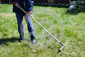 Little boy working in the garden. Work for kids outdoors